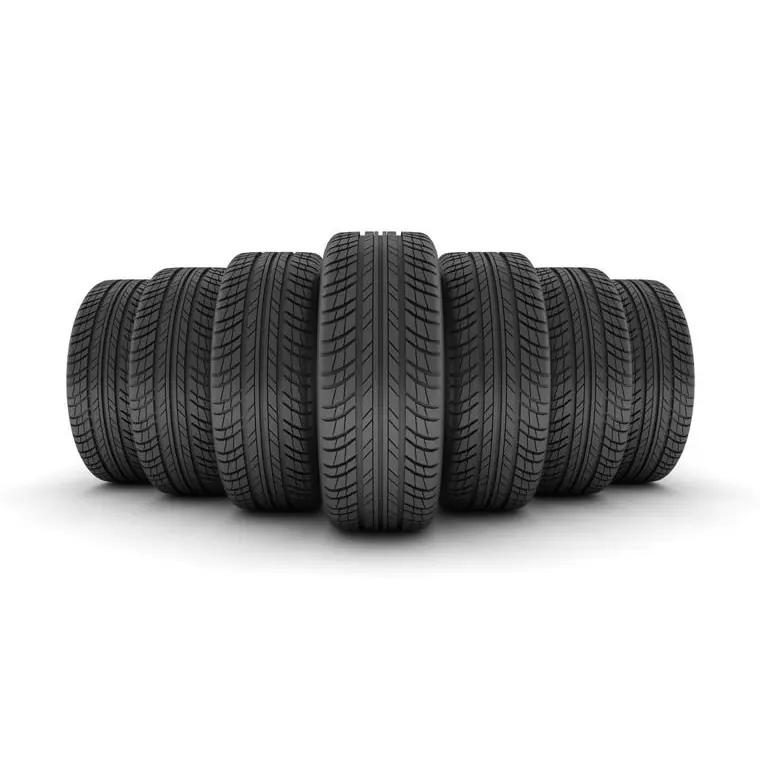 Row of used tyres photographed on a white studio background